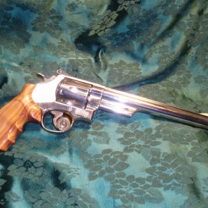 S & W Model 29-3 in .44 Magnum.  Factory nickel finish; Hogue custom Rosewood grips.